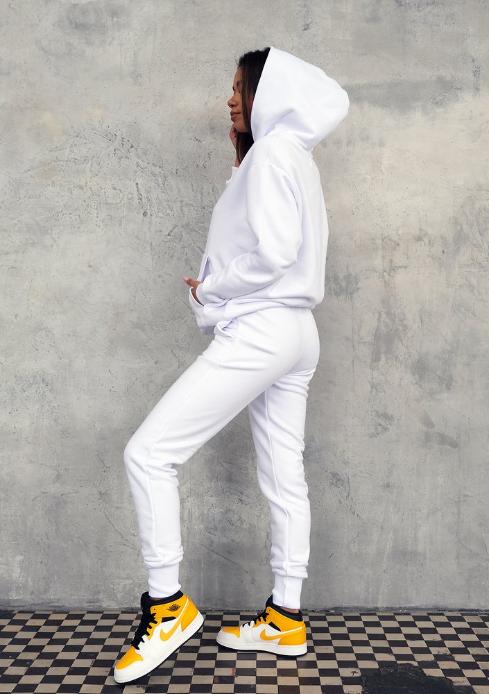 White sweatpants with a lime logo