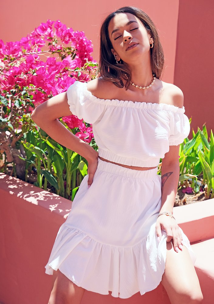Creamy white top with a boat neckline