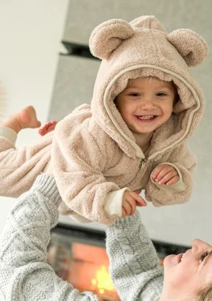 Beige plush onesie with hood and teddy ears