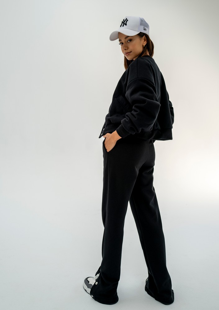 - Black snap-buttoned sweatpants