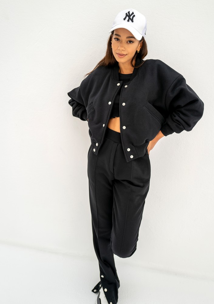 - Black snap-buttoned sweatpants