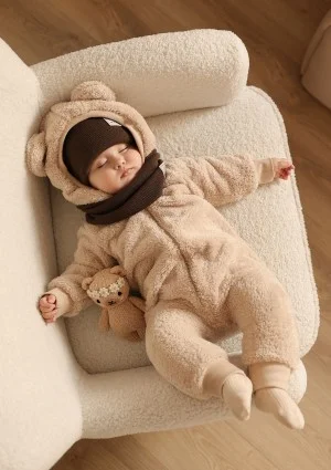 Beige plush onesie with hood and teddy ears