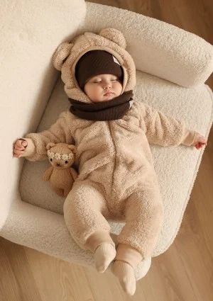 Beige plush onesie with hood and teddy ears